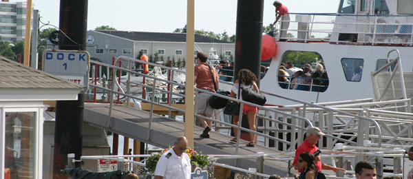 Image of a man and woman walking onto a boat while under surveillance for possible spousal infidelity and adultery